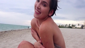 Cumshot at the beach alongside small tits brunette